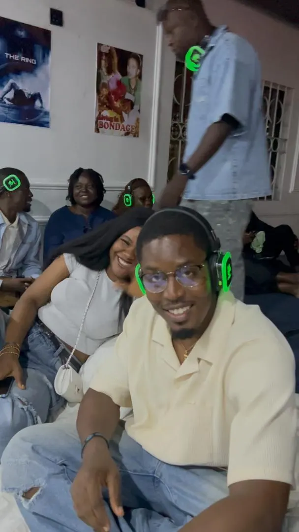 Guests smiling at the camera with their headphones on